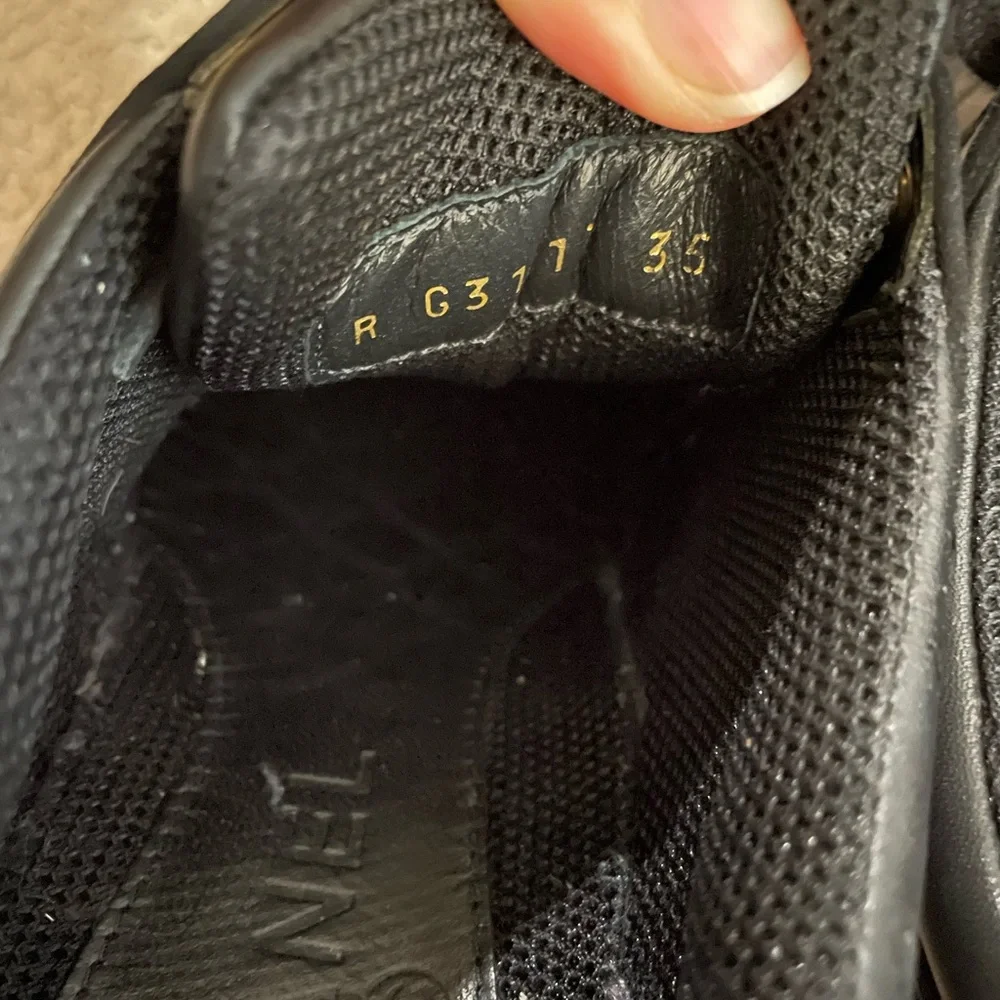 CHANEL Black Leather Low-Top Sneakers with White Accent